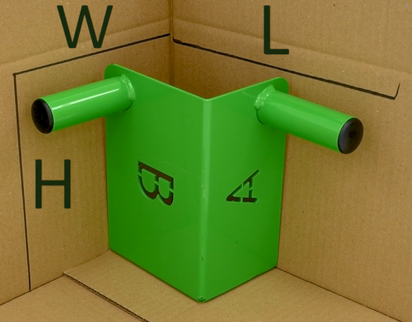 green tool inside a cardboard box labelled with length, width and height dimensions to demonstrate measuring dimensions of an irregular item